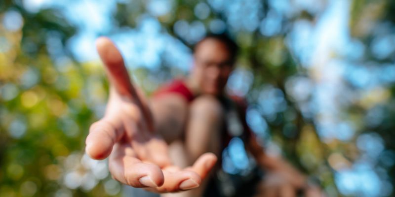 A person lendng a helping hand to someone.