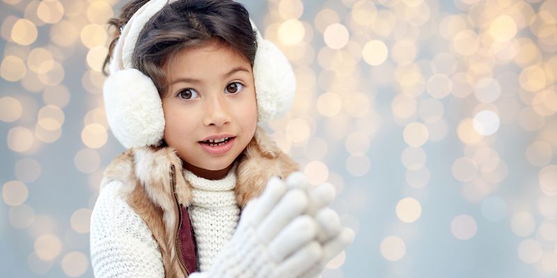 An adorable child with plush earmuffs