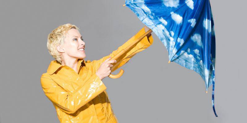 Someone opening an umbrella