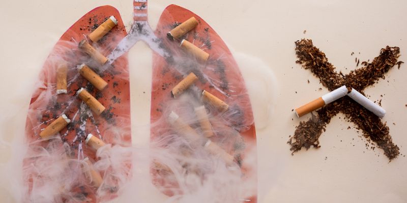 Illustration of a lung with cigarette butts in it and an x from the tobacco with a cigarette snapped in half on it.