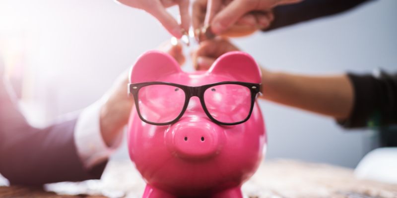 People Inserting Coins Into Piggybank