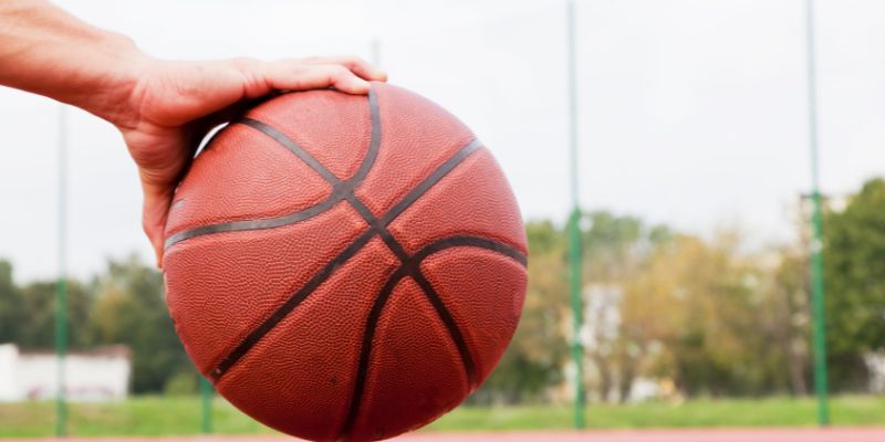 Someone gripping a basketball