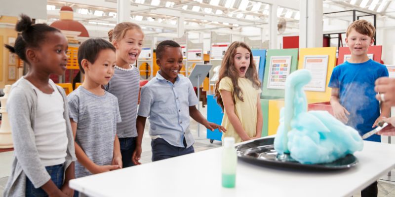 Kids Having Fun Watching an Experiment at a Science Center