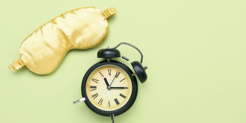 An eyemask and alarm clock