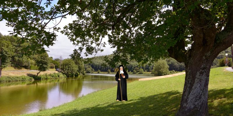 Lake of Saint-Pée-sur-Nivelle in France and an illustration of Saint Gertrude of Nivelles