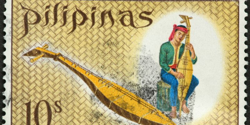 A filipino stamp with a kutiyapi instrument on it