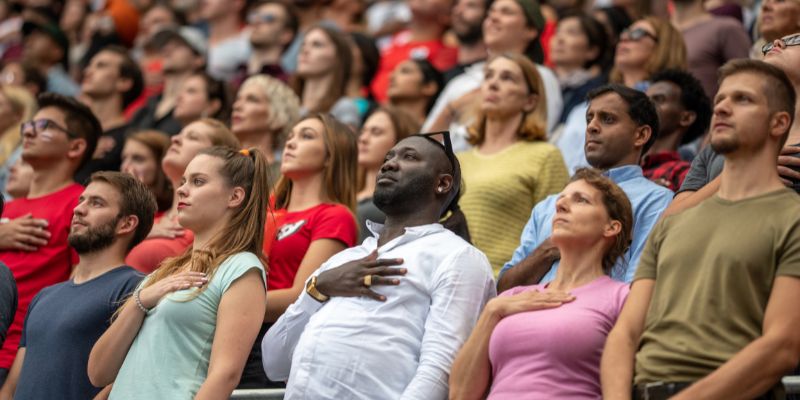 group of people pledge allegiance to the flag