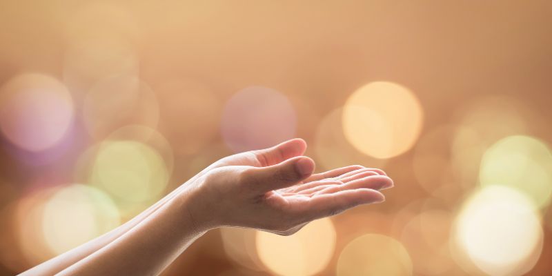 a pair of hands facing up towards the sky