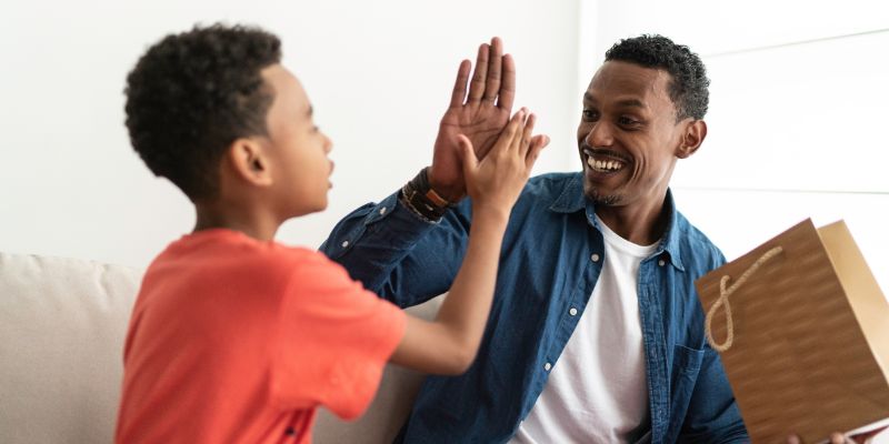 A father high-fiving their son.