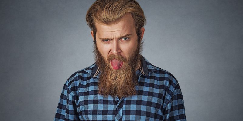 A man goofing off with his tongue hanging out