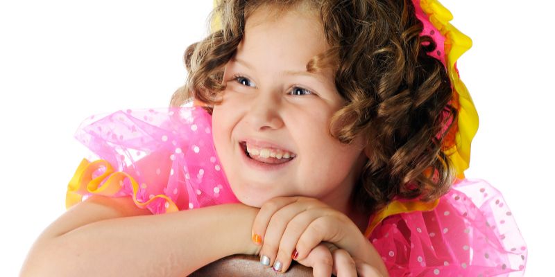 A little girl with curly hair like shirley temple