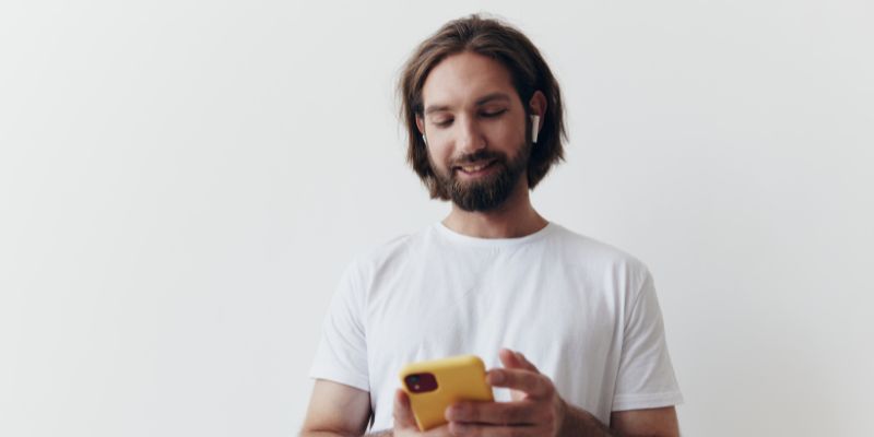 a young man with ear buds in his ear.