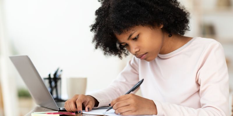 A young person wrting.