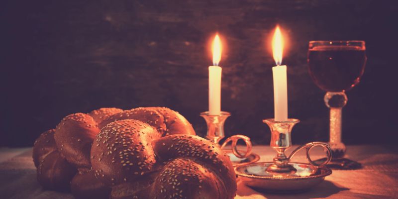 Challah and candles on a table