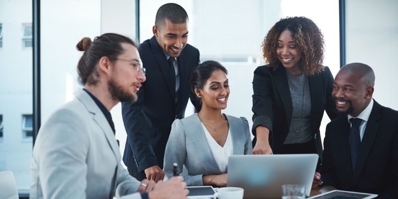 A group of employees enthusiastically working togehter. 