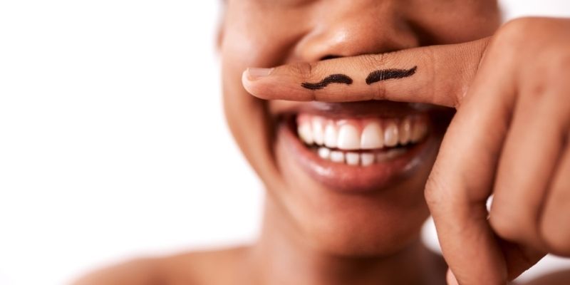 a person using their finger as a mustache