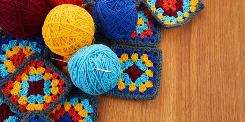 Balls of yarn and crochet pieces