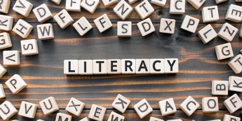 Alphabe blocks around blocks surrounding blocks that spellout literacy