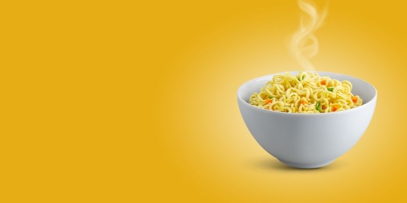a A bowl of noodles mixed with vegetables
