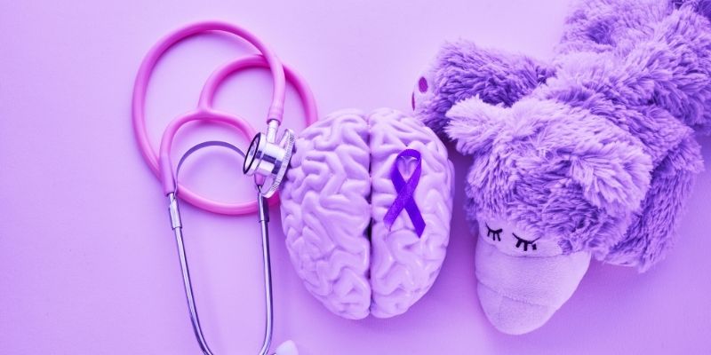 Illustration of a brain next to stuffed animal and a stethoscope