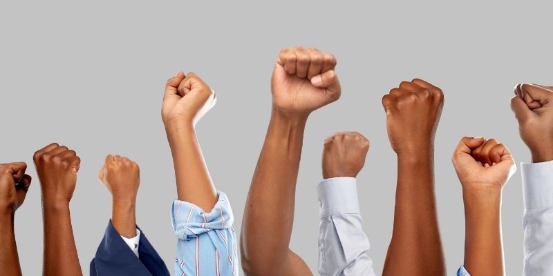 People holding up their hands in a fist