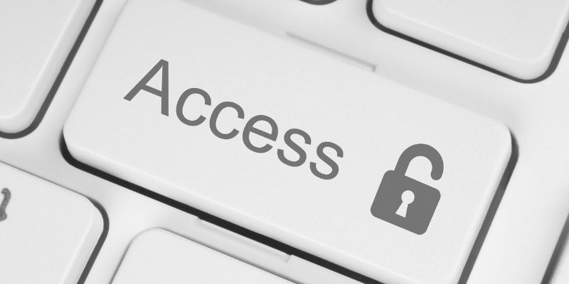A keyboard with a return key that has Access and an unlocked lock symbol