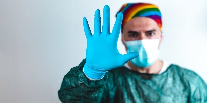 A Doctor with a rainbox medical cap on.
