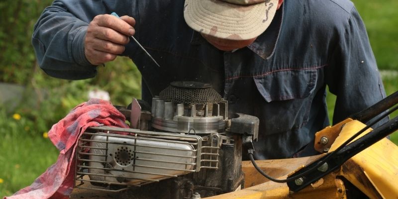 Someone working on a lawn mower.