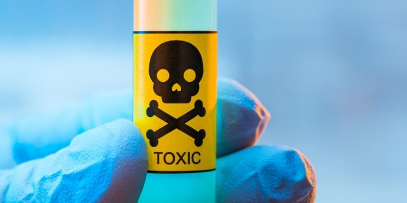 Someone holding a vial with the skeleton symbol on it.