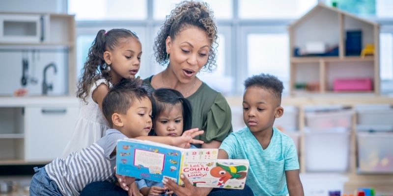 An adult reading to children.