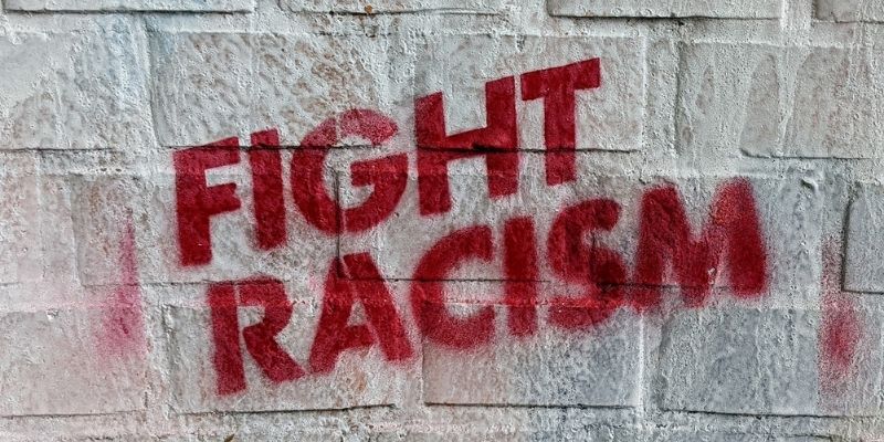 Fight racism painted on a cement wall